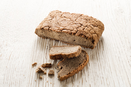 whole grain bread on white wooden backgroundの写真素材