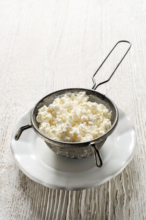 Making Fresh cottage cheese on wooden backgroundの写真素材