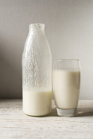 Milk kefir in a glass on wooden tableの写真素材