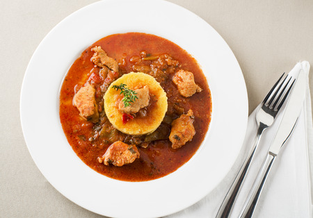 Portion of traditional meat stew - goulash on white plateの写真素材