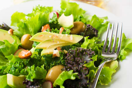 Fresh mixed green salad with avocado close upの写真素材