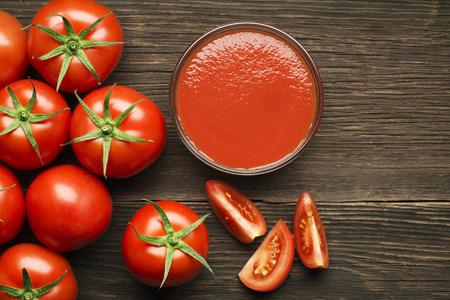 Fresh cherry tomato sauce on rustic wooden backgroundの写真素材