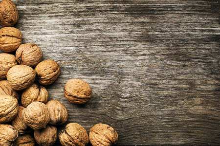 Whole nuts on a wooden background