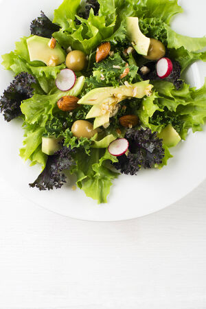 Fresh mixed green salad with avocado close upの写真素材
