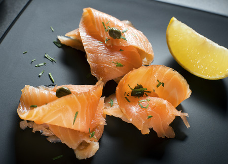 Pieces of fresh smoked salmon served on a plateの写真素材
