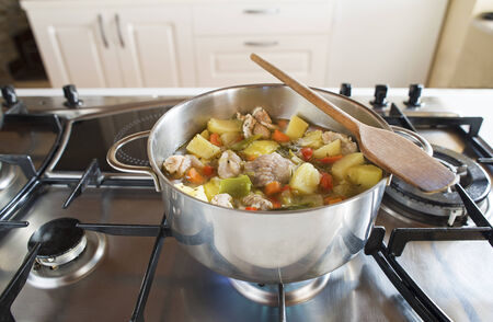 Cooking stew with vegetables and meat on the stoveの写真素材