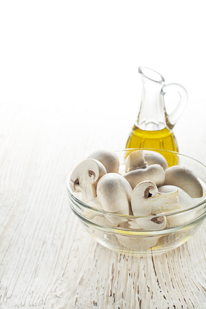 Mushrooms and olive oil on white backgroundの写真素材