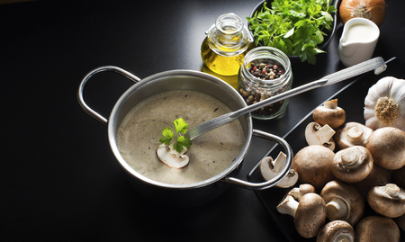 Mushroom soup with ingredients on the tableの写真素材