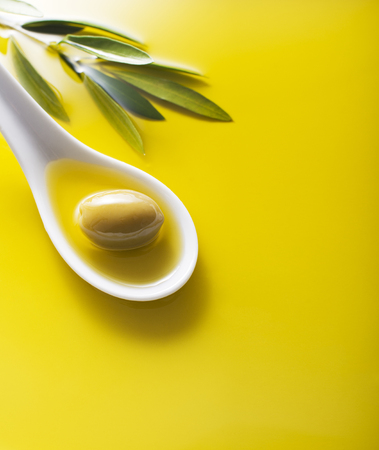 Olive fruit in oil background close upの写真素材