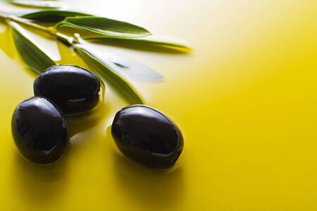Olive fruit in oil background close upの写真素材