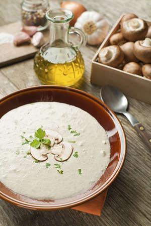 Mushroom soup with ingredients on the tableの写真素材