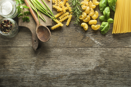 Pasta collection with herbs and spices on rustic wooden backgroundの写真素材