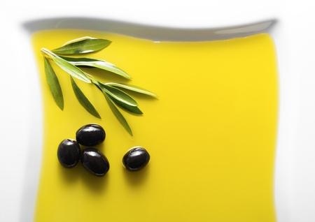 Olive fruit in oil background close upの写真素材