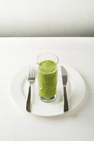 Glass of Healthy green smoothie with vegetablesの写真素材
