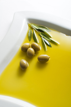 Olive fruit in oil background close upの写真素材