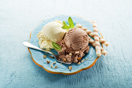 Vanilla and chocolate Ice cream on a blue plateの写真素材