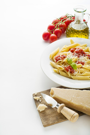Plate of penne pasta with tomato sauce and parmesan cheeseの写真素材