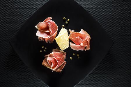 Fresh prosciutto with cheese and capers close upの写真素材