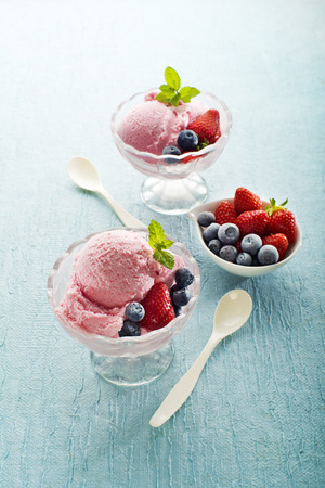 Fruit ice cream with blueberries and strawberriesの写真素材