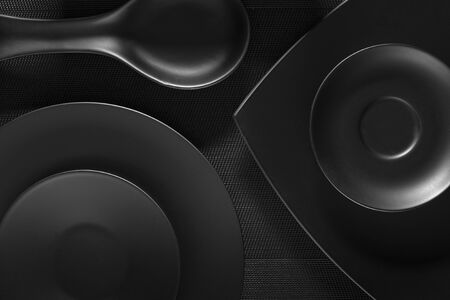 Top view of black empty plates on dark grey backgroundの写真素材