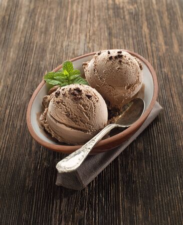 Chocolate ice cream on a wooden background close upの写真素材