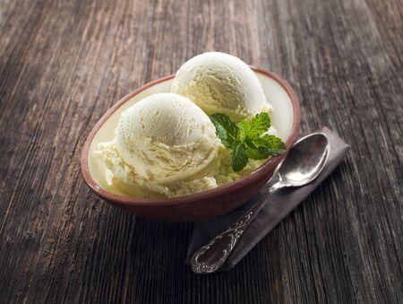 Vanilla Ice cream on a wooden background close upの写真素材