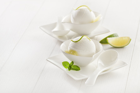 Fresh lemon and lime ice cream in a white cup.の写真素材