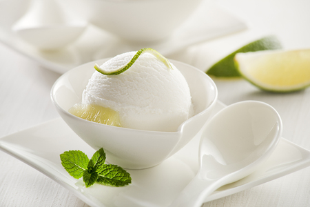 Fresh lemon and lime ice cream in a white cup.の写真素材