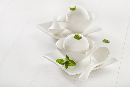 Fresh white ice cream in a white cup.の写真素材