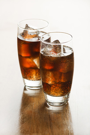 Glass of fresh cola or soda drink with ice cubes.の写真素材