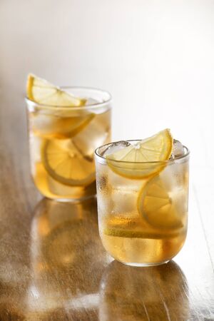 Glass of ice tea with lemon and ice cubes.の写真素材