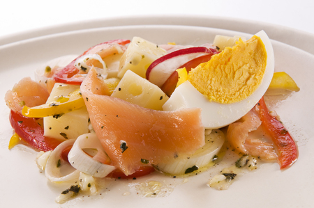 Appetizer of fresh salmon with cheese and vegetables close up.の写真素材