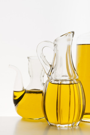 Olive oil in the bottles on white background.の写真素材