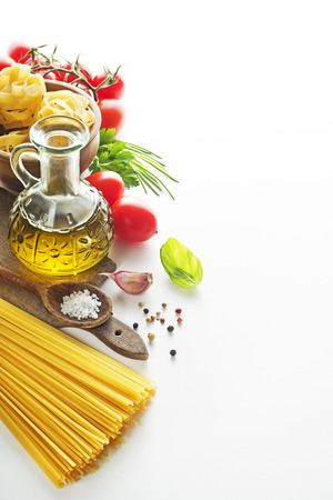 Raw Pasta with ingredients on white background.の写真素材