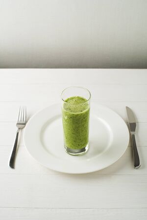 Glass of Healthy green smoothie with vegetables and fruit.の写真素材