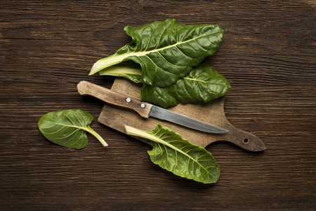 Fresh swiss chard leaves on a wooden background.の写真素材