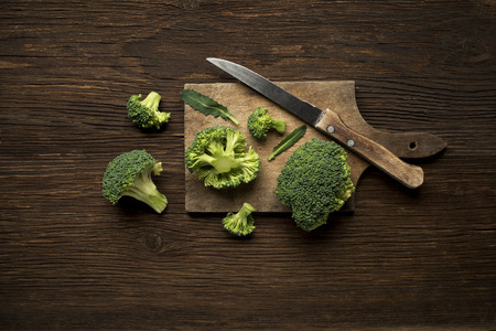 Fresh raw broccoli on a wooden background overhead shoot.の写真素材