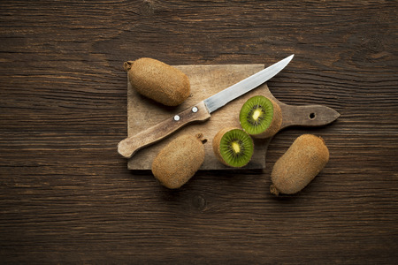 Kiwi fruits on wooden background overhead shoots.の写真素材