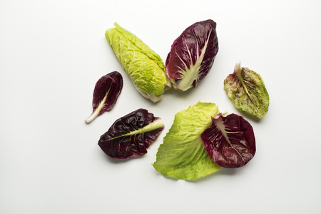 Fresh mixed salad leaves with radicchio on a white background.の写真素材