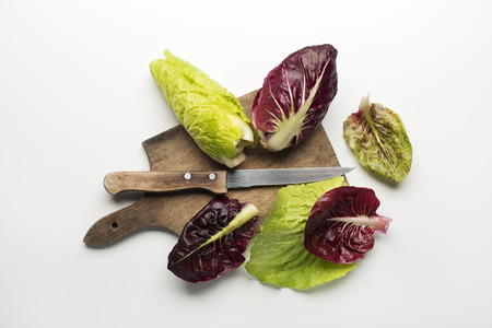 Fresh mixed salad leaves with radicchio on a white background.の写真素材