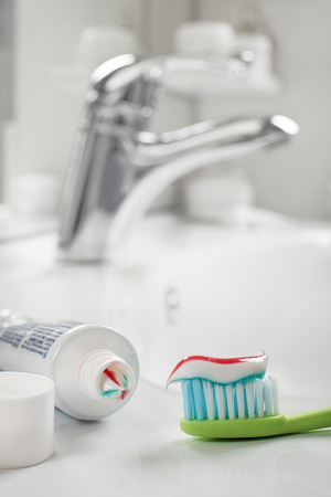 Toothbrush and toothpaste in the bathroom close up.の写真素材