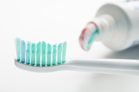 Toothbrush and toothpaste on white background close up.の写真素材
