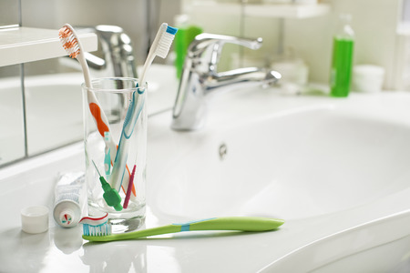 Toothbrush and toothpaste in the bathroom close up.の写真素材