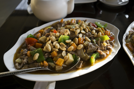 Chinese food - stir fry beef with vegetables and nuts.の写真素材