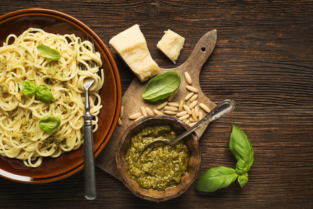 Fresh spaghetti with basil pesto on wooden backgroundの写真素材