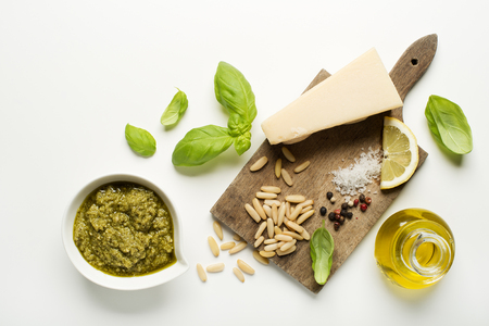 Fresh basil pesto ingredients on white background overhead shoot.の写真素材