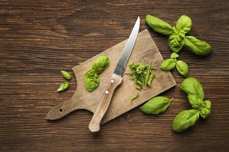 Fresh basil leaves on wooden background close up.の写真素材