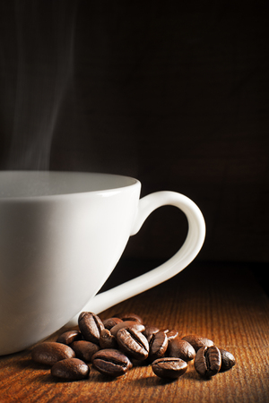 Coffee cup and beans on a wooden background.の写真素材