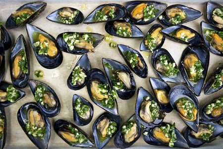 Fresh mussels with garlic, parsley and olive oil close upの写真素材