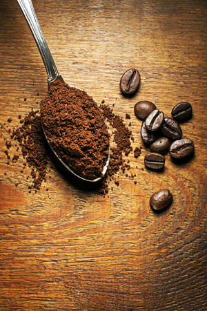 Fresh ground Coffee in spoon on wooden backgroundの写真素材